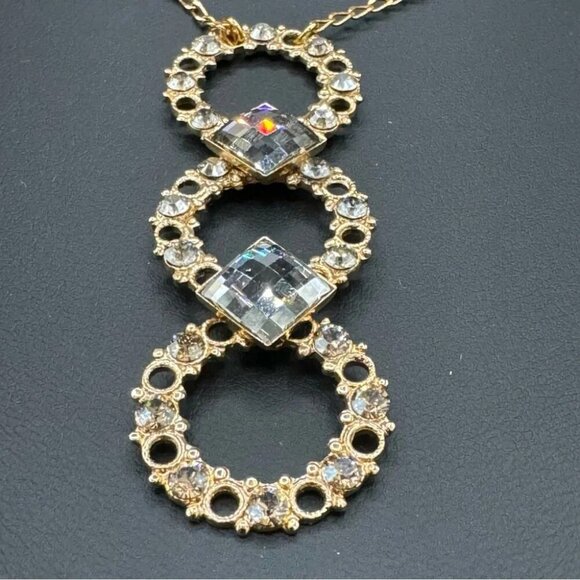 Belladonna Circular Crystal and Gold Tone Infinity Pendant Necklace - Picture 11 of 17